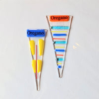 Colorful oregano spice sticks with labeled ends on a white background