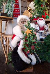 Decorative scene with a Santa Claus figure on a dark surface