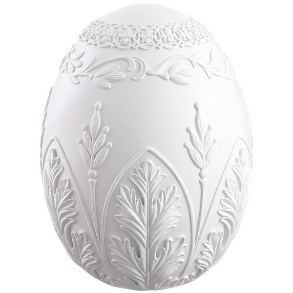Decorative white egg with intricate patterns on a white background