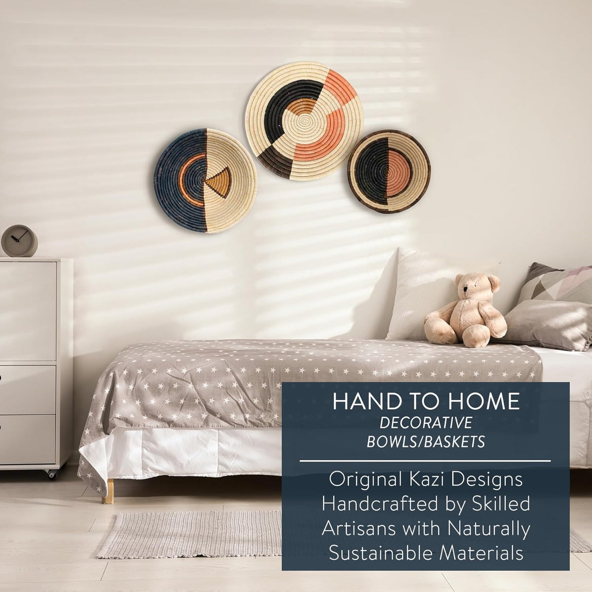 Decorative bowls on a wall above a bed with a teddy bear, featuring 'Hand to Home' branding and featured details.