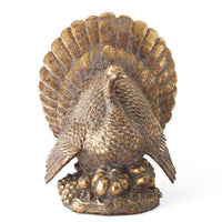 Bronze turkey figurine on a white background