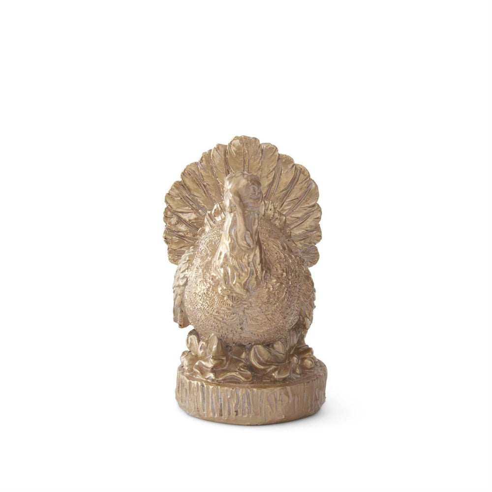 Decorative gold turkey figurine on a white background