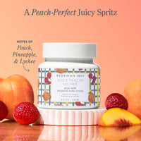 Bottle of Beekman 1802 Juicy Peachy Lychee whipped body cream with peach, pineapple, and lychee elements on a peach background.