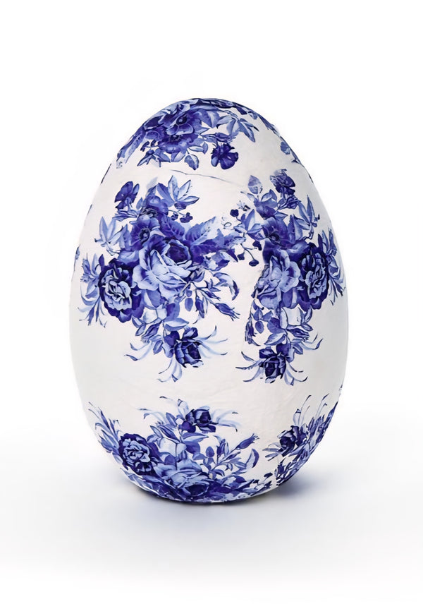 Decorative egg with blue floral pattern on a white background