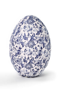 Decorative egg with blue floral pattern on a white background