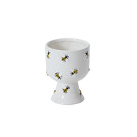 White ceramic compote with bee pattern on a white background
