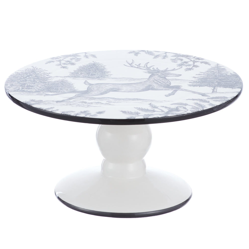 A round pedestal table featuring a white tabletop with a gray toile-style print of a deer and trees, supported by a glossy white round pedestal base with a thin black rim.