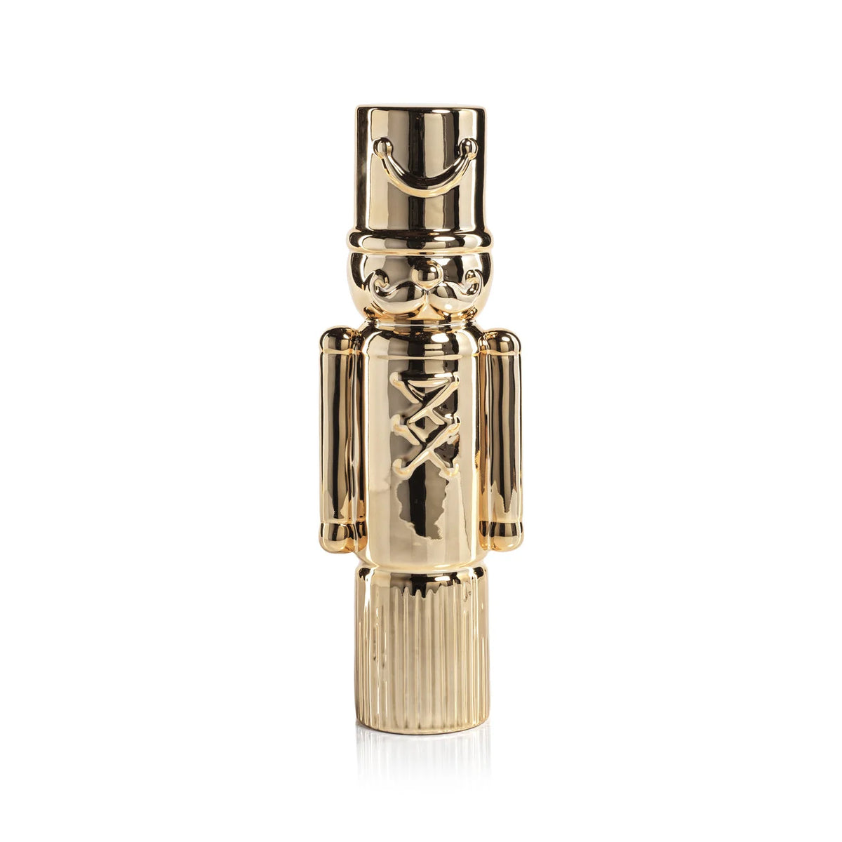 Gold nutcracker-shaped figurine on a white background