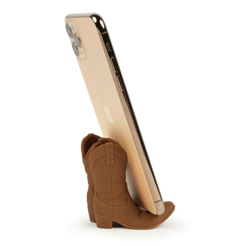 Phone stand shaped like a brown cowboy boot on a white background
