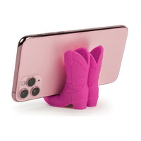 Pink cowboy boot phone holder with a smartphone on a white background