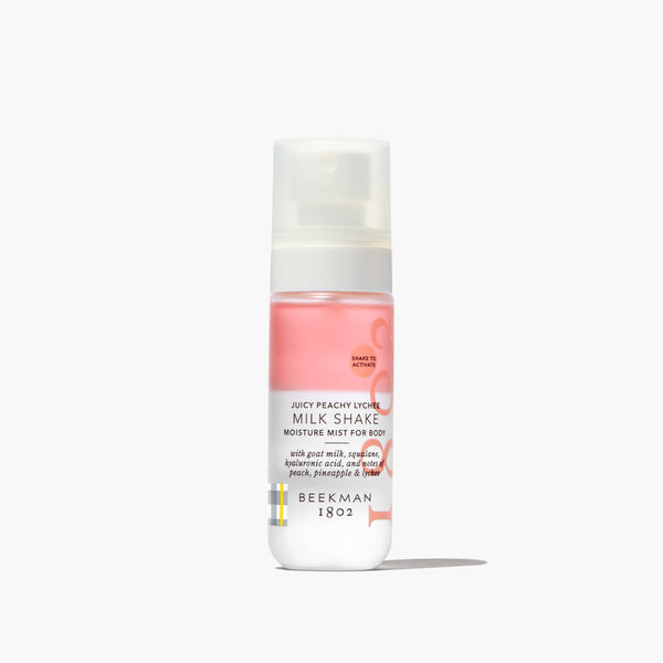 Bottle of Beekman 1802 Milk Shake Moisture Mist for Body on a white background