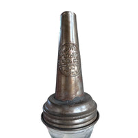 Vintage metal bottle stopper with branding on a white background