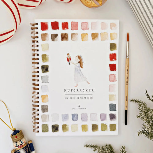 Watercolor workbook titled 'Nutcracker' with color swatches on a white surface.