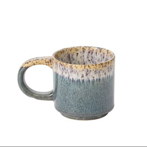 Speckled blue and brown ceramic mug on a white background