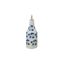 Decorative oil cruet with blue floral patterns on a white background