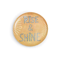 Round melamine plate with 'Rise & Shine' text on a white background