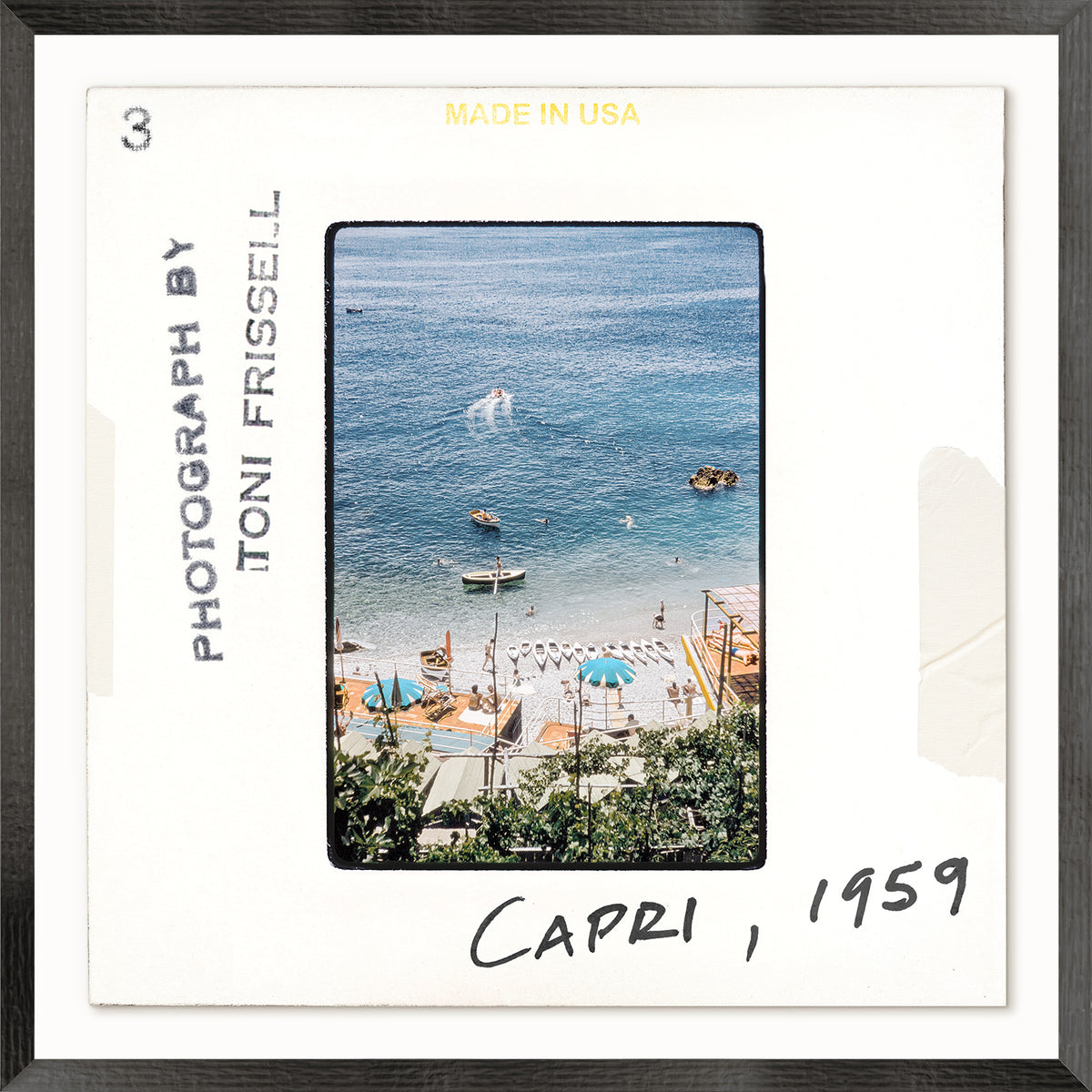 Framed photograph of a beach scene in Capri, 1959, with text indicating the photographer and year.