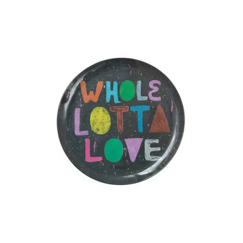 A round melamine plate featuring the phrase 'WHOLE LOTTA LOVE' in colorful, hand-drawn style letters on a plain white background.