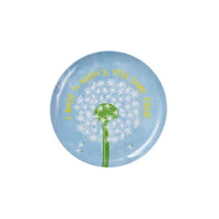 Round blue melamine plate with dandelion design and text on a white background