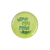 A round light green melamine plate with the text 'WORLD PEAS PLEASE' in dark green lettering, accompanied by a small illustration of green peas on a leaf, shown on a plain white background.